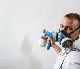 worker-painting-wall-with-spray (Medium)